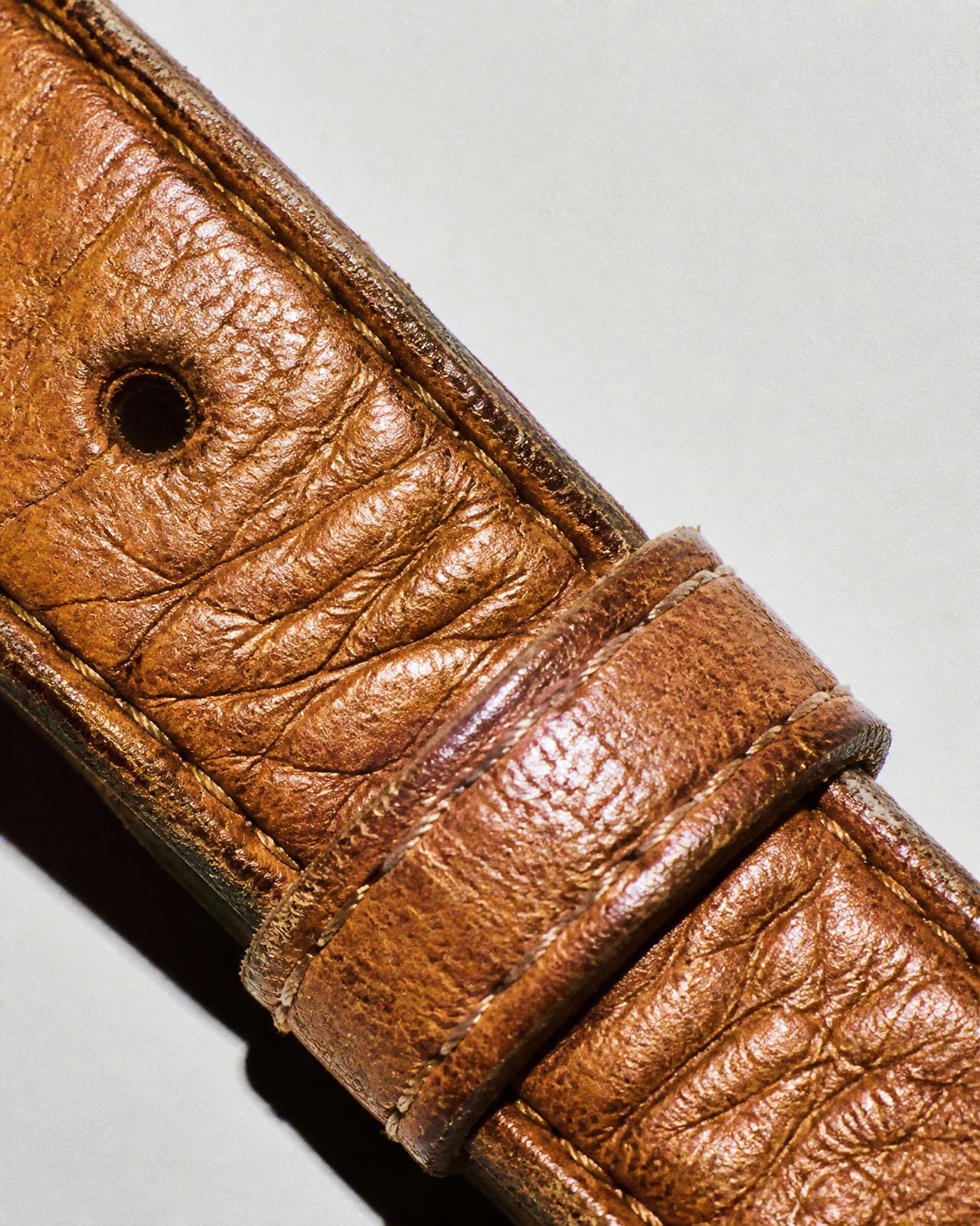 Macro detail of vegetable-tanned bridle leather and stitching